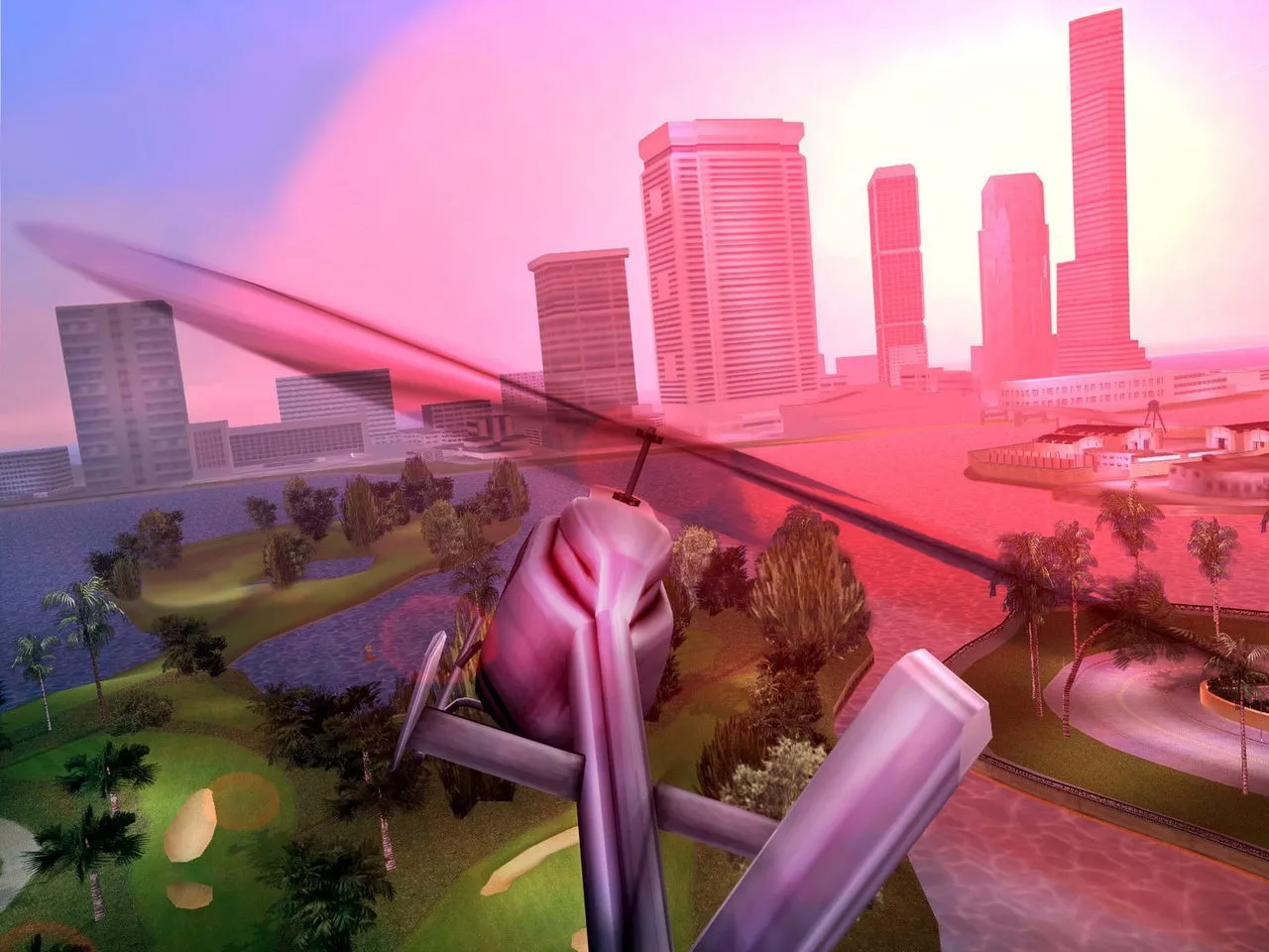 A helicopter flying over the Vice City sky at sunset